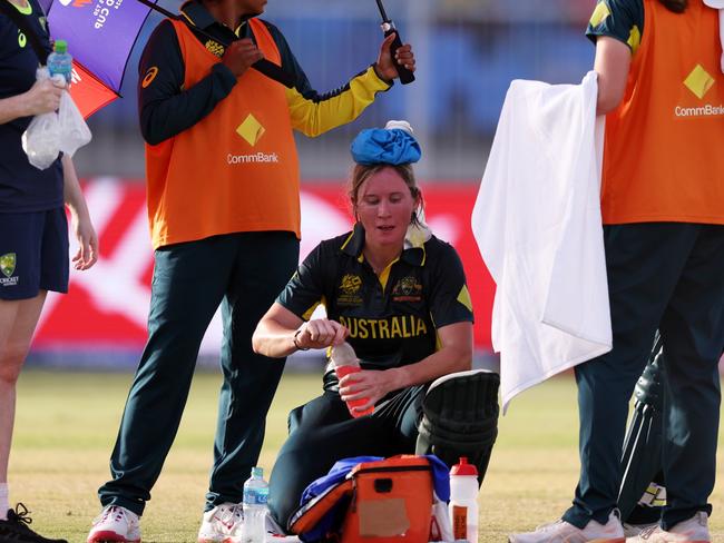 SHARJAH, UNITED ARAB EMIRATES - OCTOBER 05: Beth Mooney of Australia cools down with an ice pack in a drinks break, during the ICC Women's T20 World Cup 2024 match 5 between Australia and Sri Lanka at Sharjah Cricket Stadium on October 05, 2024 in Sharjah, United Arab Emirates. (Photo by Matthew Lewis-ICC/ICC via Getty Images)