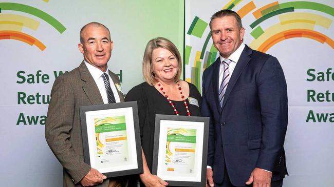 Shane Webcke (right) presents a Work Safe award to Bradley and Kerryn Piggott during one of his many public appearances in Queensland this year. Picture: contributed