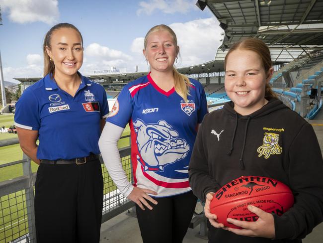 AFLW North Melbourne footballer Nicole Bresnehan with juniors Peyton Webster, 14, and Ella Jones 12, at Sunday’s International Women’s Day football event at Blundstone Arena. Picture: Chris Kidd