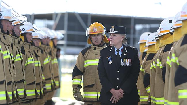 Katarina Carroll inspects new Fire and Emergency Services graduates.