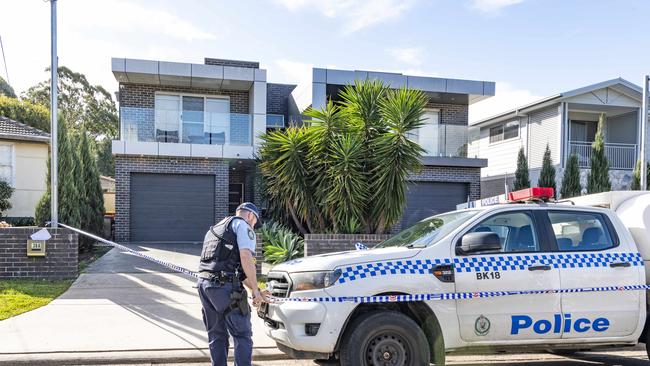 Police at Panania, where a car was towed away following the shooting. Picture: Monique Harmer