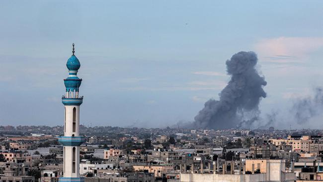 A picture taken from Rafah shows smoke billowing over Khan Yunis in the distance following an Israeli bombardment of the southern Gaza Strip. Picture: Said Khatib / AFP