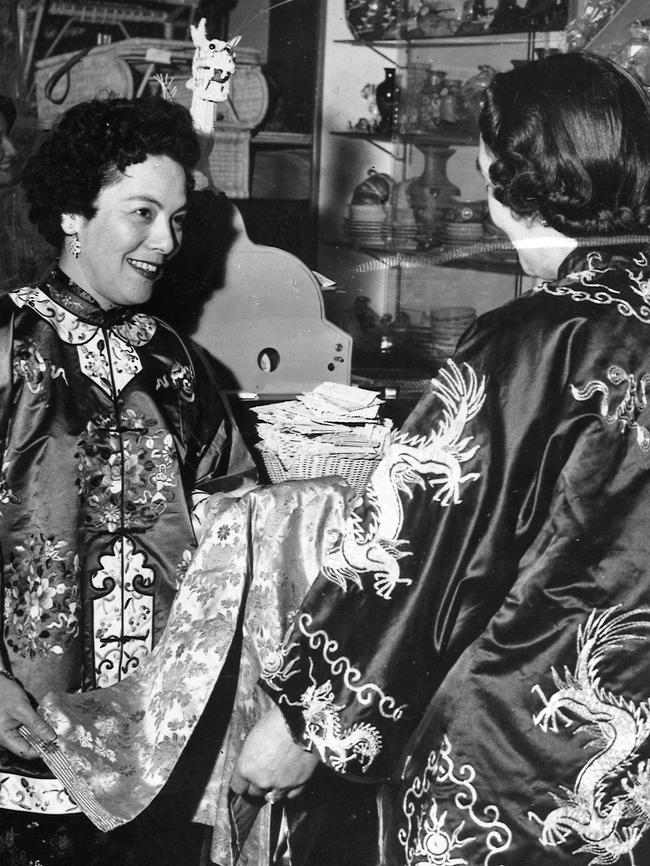 Kimlarn Shee and Alma Quon try on beautiful Chinese costumes in Chinatown in 1959. Picture: HWT Library.