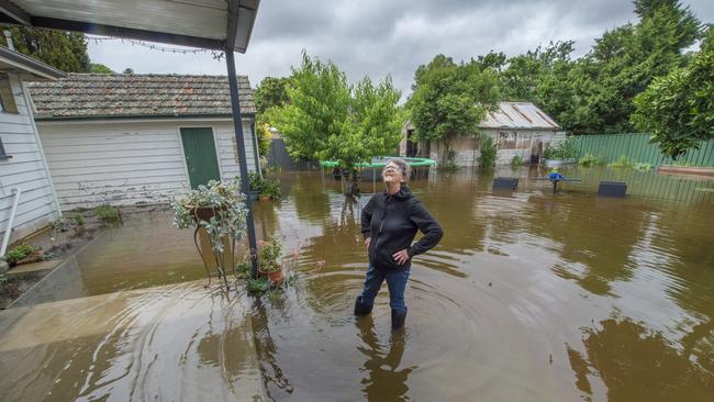 Maureen Bromley in a flooded back yard. Picture: Rob Leeson.