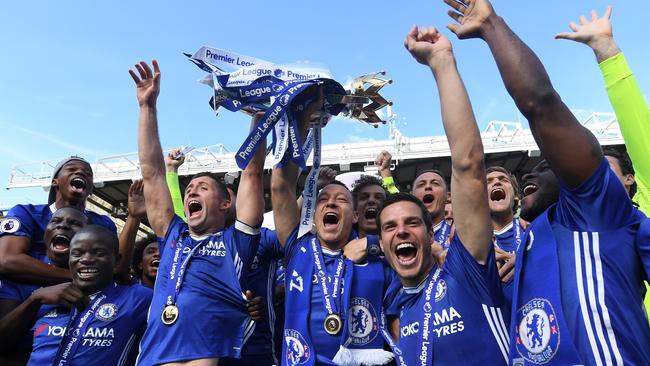 Gary Cahill of Chelsea and John Terry of Chelsea lift the Premier League Trophy.