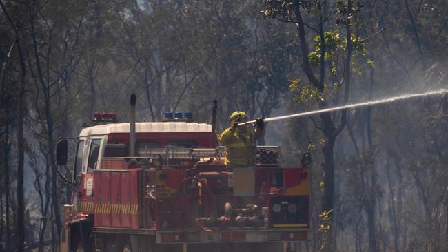 Firefighters work to bring the Gunn Point Road fire under control on Friday while working in windy conditions. Picture: Che Chorley