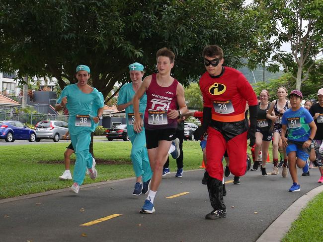 Miguel Groth, Astia Neckebroek, Zac Bennett and Patrick Markert lead the pack in the Cairns Regional Council's New Year's Eve superhero fun run on the Cairns Esplanade. Picture: Brendan Radke
