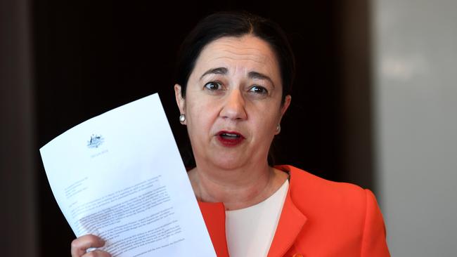 Queensland Premier Annastacia Palaszczuk holds a letter from Federal Treasurer Scott Morrison (AAP Image/Dan Peled)