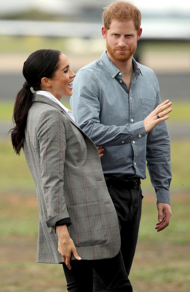 Meghan laughs as Harry swats flies. Picture: Cameron Spencer/Getty Images.