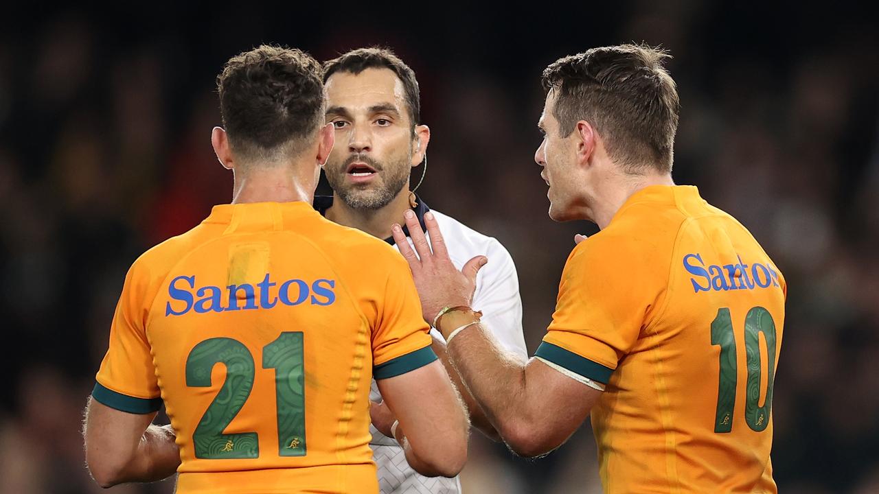 Referee Mathieu Raynal speaks with Nic White and Bernard Foley of the Wallabies at Marvel Stadium on September 15, 2022 in Melbourne.  Photo: Getty Images