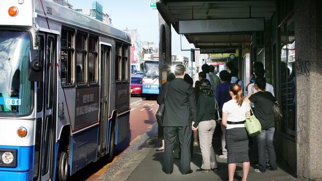 Commuters wait for several packed buses on Parramatta Road.