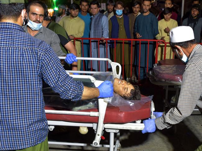 Volunteers and medical staff bring an injured man on a stretcher to a hospital for treatment after two ISIS bombings at the Kabul airport. Picture: AFP