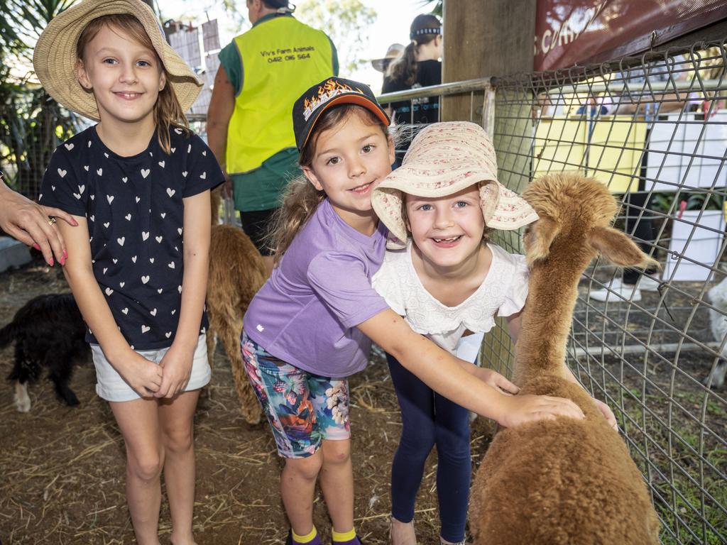 (from left) Imogen Hinrichsen, Alyssa Hinrichsen and Lily Porter enjoy Viv's Farm Animals at the Toowoomba Royal Show. Friday, March 25, 2022. Picture: Nev Madsen.