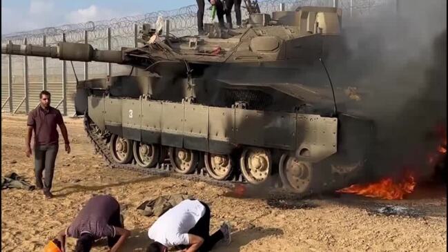 Palestinians celebrate near purported Israeli tank