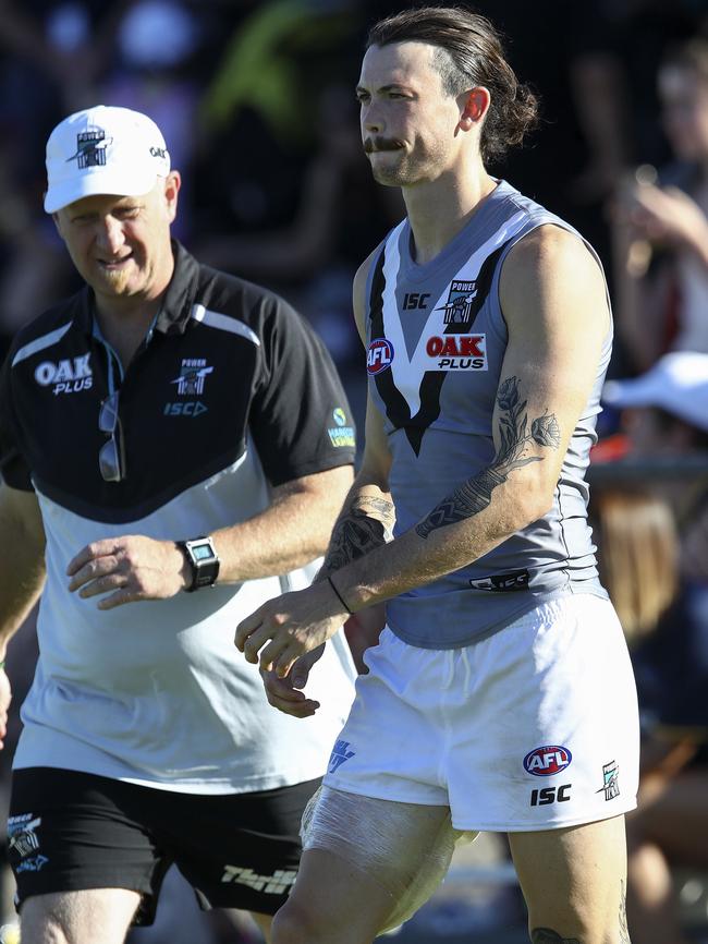 Injured defender Jasper Pittard walks off Alberton Oval. Picture: Sarah Reed