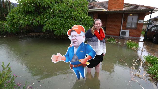 Chelsea Pister at her Woodville North home during a water main burst in May last year — with cardboard Ian Hunter. Picture: Tait Schmaal