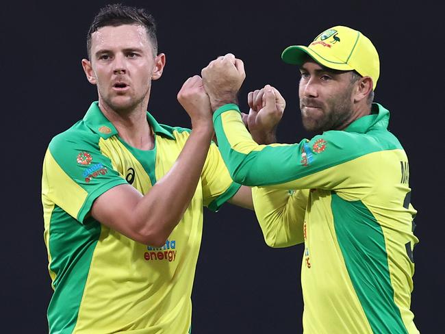 Josh Hazlewood celebrates with Glenn Maxwell after taking the wicket of Shikhar Dhawan during game two of the One Day International series between Australia and India at Sydney Cricket Ground. Picture: Ryan Pierse