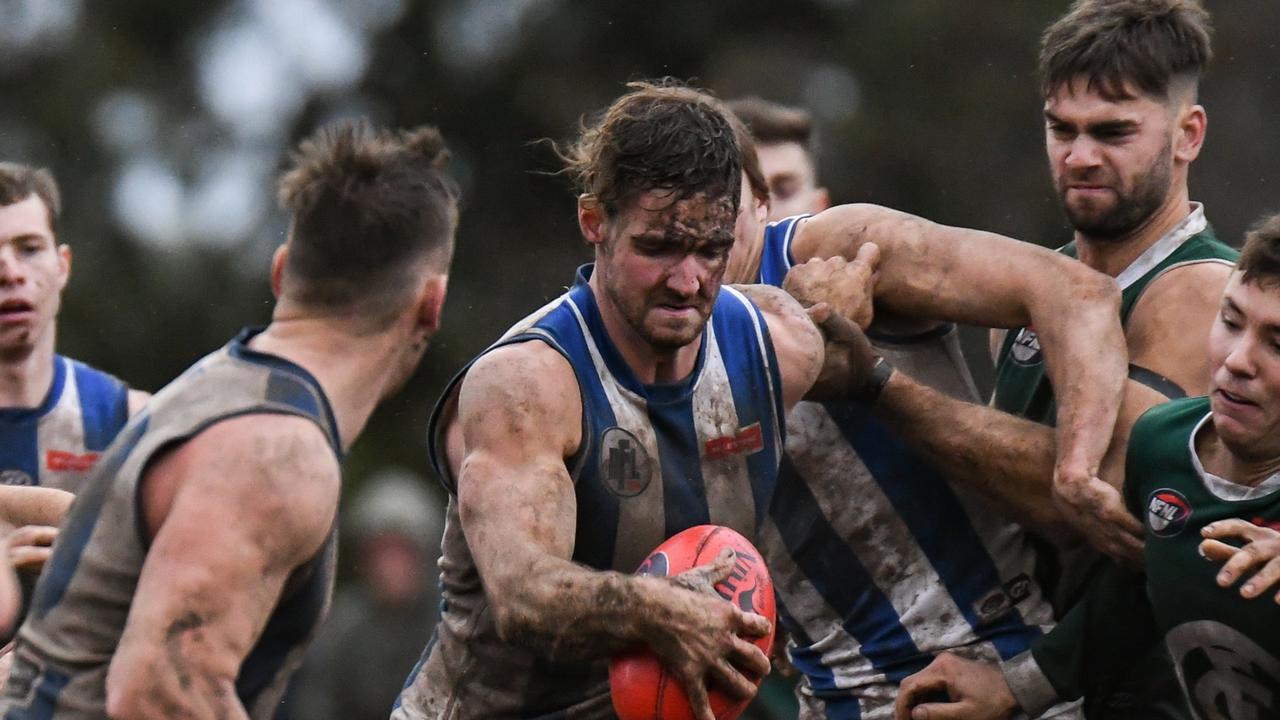 Macleod and Greensborough slog it out in the wet in the Northern Football League. Pictures: Nathan McNeill.