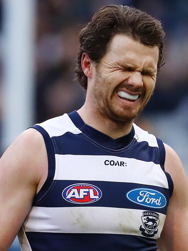 Patrick Dangerfield grimaces with pain following Geelong’s three-point triumph over Hawthorn on Saturday. Picture: Michael Klein