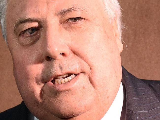 Businessman Clive Palmer is flanked by four security guards as he leaves the Federal Court in Brisbane Friday, Sept. 9, 2016. The former federal MP has given evidence under oath about the demise of Queensland Nickel, which was put into liquidation earlier this year. (AAP Image/Dave Hunt) NO ARCHIVING