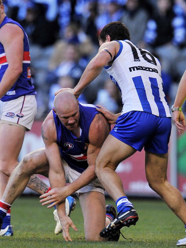 Scott Thompson gets stuck into Barry Hall as he tries to do his shoe laces up …