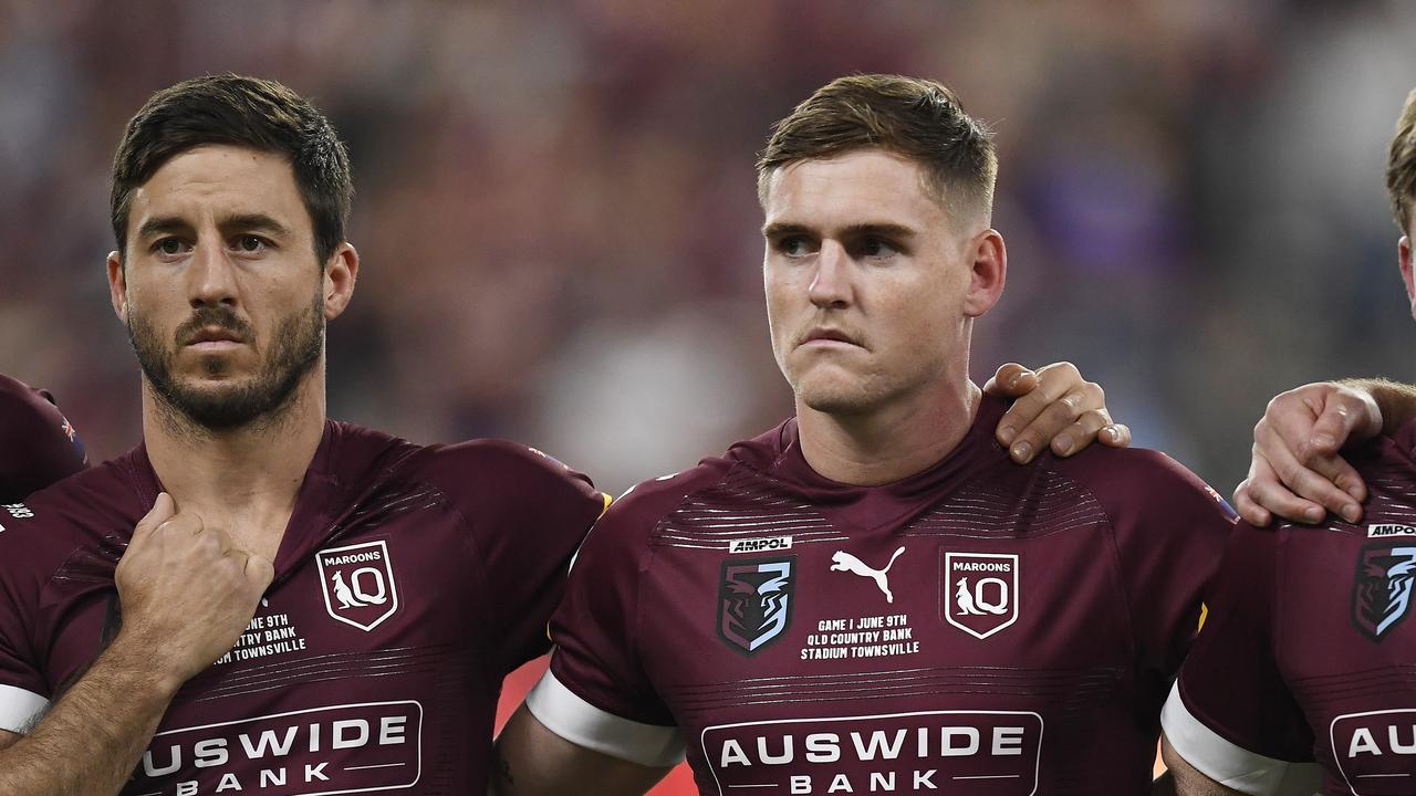 TOWNSVILLE, AUSTRALIA - JUNE 09: Ben Hunt of the Maroons, Alexander Brimson of the Maroons and Harry Grant of the Maroons sing the national anthem before game one of the 2021 State of Origin series between the New South Wales Blues and the Queensland Maroons at Queensland Country Bank Stadium on June 09, 2021 in Townsville, Australia. (Photo by Ian Hitchcock/Getty Images)