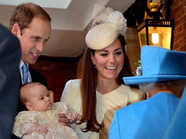 Prince William, Duke of Cambridge and Catherine, Duchess of Cambridge, with Queen Elizabeth II as they hold their son Prince George. Picture: AFP