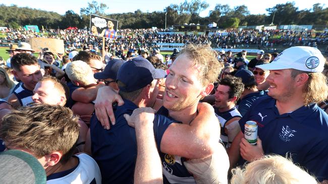 Yarrawonga’s Leigh Williams is swamped by fans after the grand final win over Albury. Picture: Yuri Kouzmin