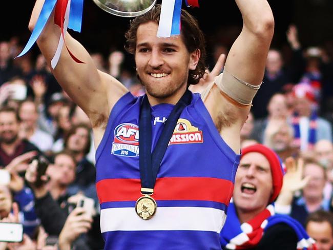 MELBOURNE, AUSTRALIA - OCTOBER 01: Marcus Bontempelli of the Bulldogs celebrate with the Premiership Cup after the 2016 Toyota AFL Grand Final match between the Sydney Swans and the Western Bulldogs at the Melbourne Cricket Ground on October 01, 2016 in Melbourne, Australia. (Photo by Ryan Pierse/AFL Media/Getty Images) *** BESTPIX ***