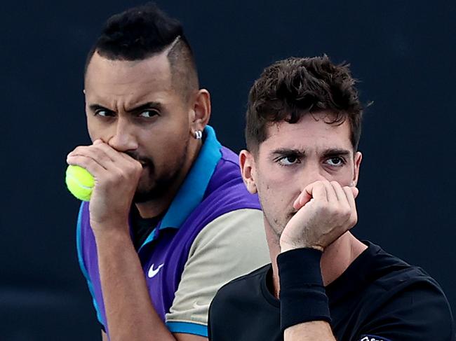 MELBOURNE, AUSTRALIA - FEBRUARY 13: Nick Kyrgios and Thanasi Kokkinakis of Australia talk tactics in their Men's Doubles second round match against Lloyd Harris of South Africa and Julian Knowle of Austria during day six of the 2021 Australian Open at Melbourne Park on February 13, 2021 in Melbourne, Australia. (Photo by Mark Metcalfe/Getty Images)