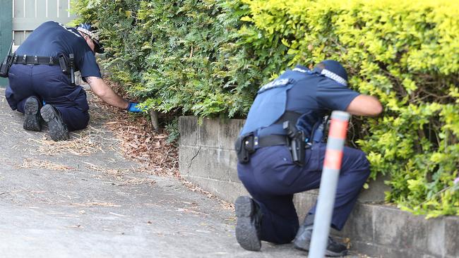 Police search gardens in Toowong, near where the mother was found. Pic: Jack Tran