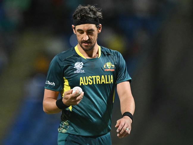 Australia's Mitchell Starc checks the ball before bowling during the ICC men's Twenty20 World Cup 2024 Super Eight cricket match between Australia and Bangladesh at Sir Vivian Richards Stadium in North Sound, Antigua and Barbuda, on June 20, 2024. (Photo by ANDREW CABALLERO-REYNOLDS / AFP)