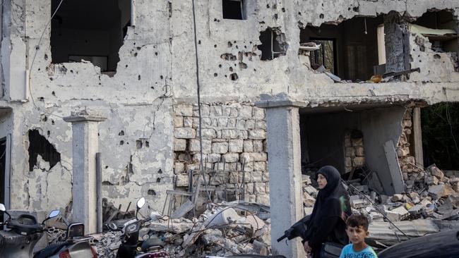 People are seen standing in front of an apartment block destroyed in a recent Israeli strike on August 24, 2024 in Mays Al-Jabal, Lebanon. Picture: Chris McGrath/Getty Images