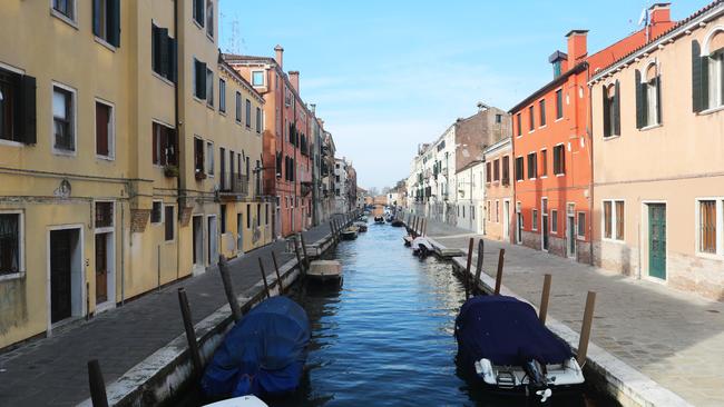 A Venice canal and the roads next to it are left completely empty. Picture: Getty Images/