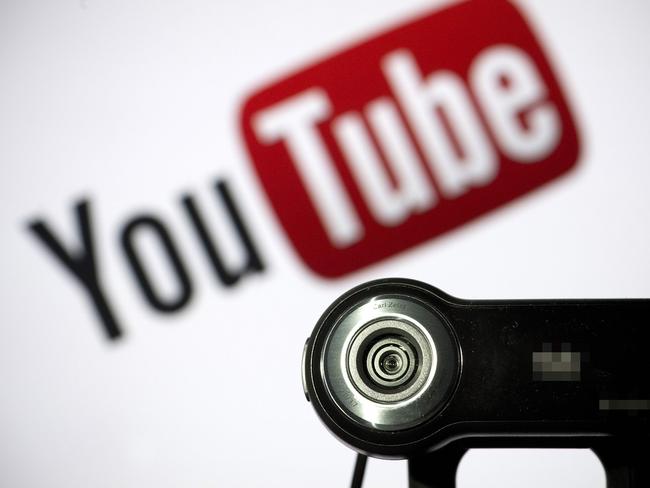 (FILES) In this file photo taken on June 28, 2013 a webcam is positioned in front of YouTube's logo in Paris. - YouTube said May 26, 2020 it was investigating the removal of comments critical of the Chinese Communist Party from the video-sharing platform, saying the filtering appeared to be "an error."The comments from the Google-owned video service came after a media report in The Verge prompted by complaints from technology entrepreneur Palmer Luckey. (Photo by LIONEL BONAVENTURE / AFP)