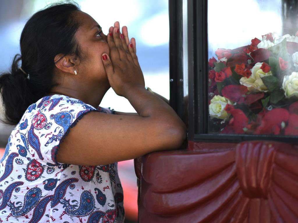 A woman prays at St Sebastian's Church in Negombo. The death toll from the bomb blasts that ripped through churches and luxury hotels in Sri Lanka has risen dramatically to 290. Picture: AFP 