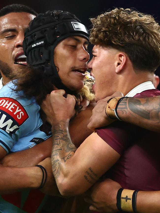 Jarome Luai of the Blues and Reece Walsh of the Maroons scuffle. (Photo by Chris Hyde/Getty Images)