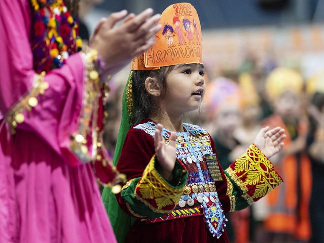 Emma Ahmadi stands with fellow students of the Afghanistan community during Harmony Day celebrations at Darling Heights State School. Picture: Kevin Farmer