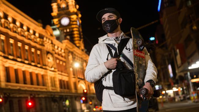 Tysn Dearley heads to a St Kilda refuge before curfew on Sunday. Picture: Paul Jeffers