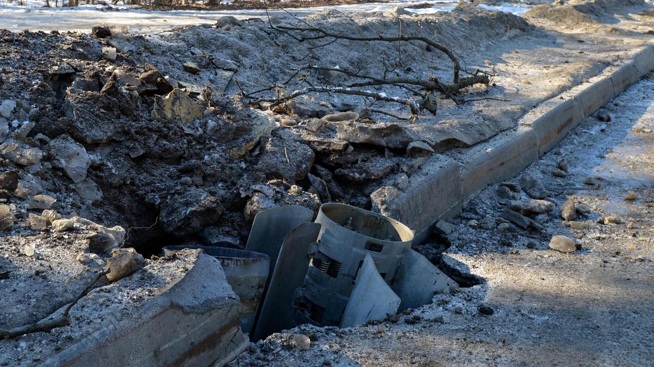 A rocket body stuck into a road after shelling on the northern outskirts of Kharkiv on February 24. Picture: AFP