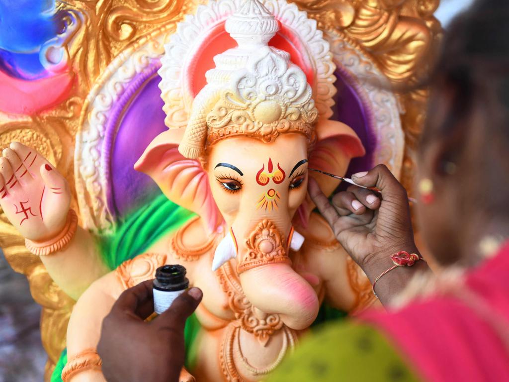 An artisan gives final touches to an idol of the elephant-headed Hindu god Lord Ganesha ahead of the Ganesh Chaturthi festival, at a workshop on the outskirts of Amritsar on September 4, 2021. Picture: Narinder Nanu/AFP