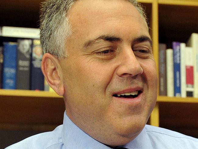 Australia's federal treasurer Joe Hockey smiles as he holds his budget speech at Parliament House in Canberra on May 13, 2014. Australian Prime Tony Abbott worked to sell his government's first budget as one that will be painful but crucial for the nation's future as he braces for a voter backlash. AFP PHOTO