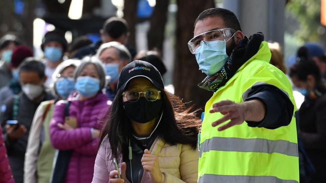 Sydneysiders wait in a queue outside a Covid-19 vaccination centre in the Homebush. Picture: AFP