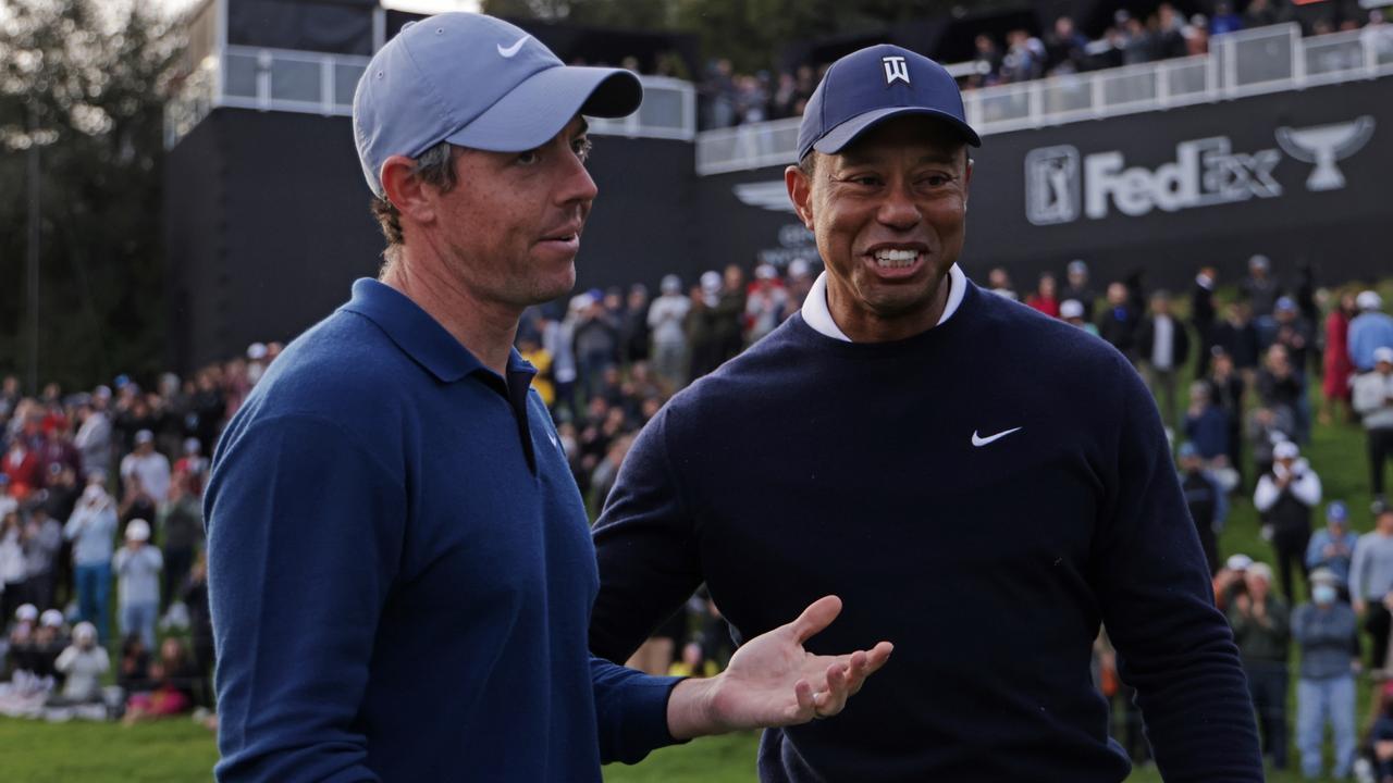 PACIFIC PALISADES, CALIFORNIA - FEBRUARY 16: Rory McIlroy of Northern Ireland (L) and Tiger Woods of the United States meet on the 18th green during the first round of the The Genesis Invitational at Riviera Country Club on February 16, 2023 in Pacific Palisades, California. (Photo by Harry How/Getty Images)