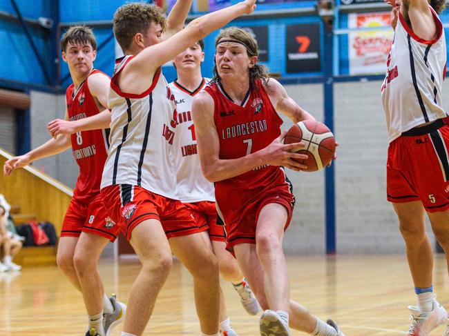 Logan Gibson of Launceston Lightning Red drives against Launceston Lightning Black in the under-18s.