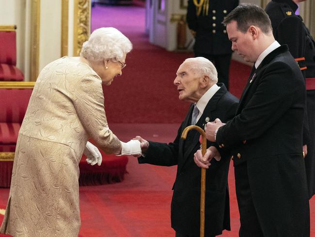 The Queen wore gloves during an investiture ceremony at Buckingham Palace, something she hasn’t done since 1954. Picture: AP