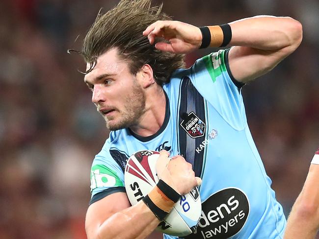 BRISBANE, AUSTRALIA - NOVEMBER 18: Angus Crichton of the Blues is tackled during game three of the State of Origin series between the Queensland Maroons and the New South Wales Blues at Suncorp Stadium on November 18, 2020 in Brisbane, Australia. (Photo by Chris Hyde/Getty Images)