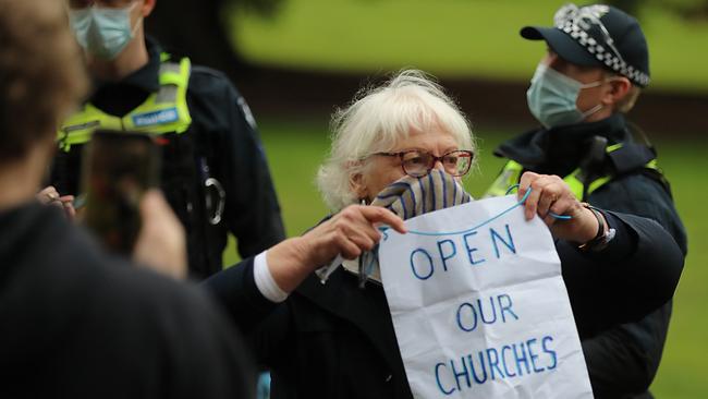 A woman protests in Fitzroy Gardens. Picture: Alex Coppel.