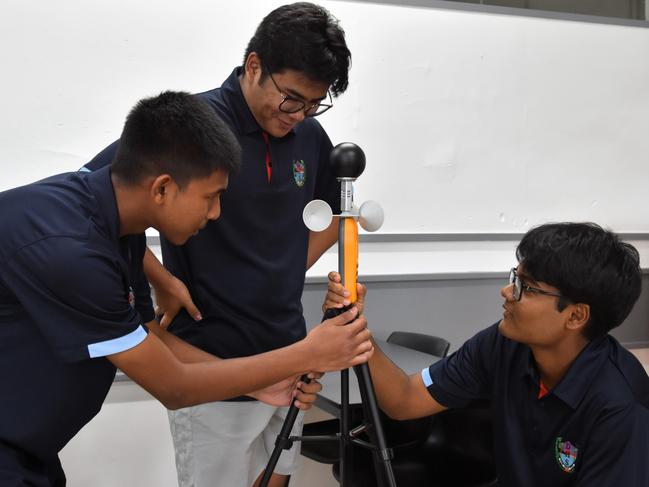 Darwin High School students Monishi Rangchak Tripura, Pothik Vincent Mondol, and Mohammad Niyaz Hasan have devised a strategy to cool rooms cheaply through apparent temperature optimisation. Picture: Sierra Haigh