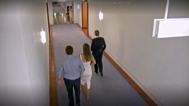 Bruce Lehrmann and Brittany Higgins are seen walking through parliament house.